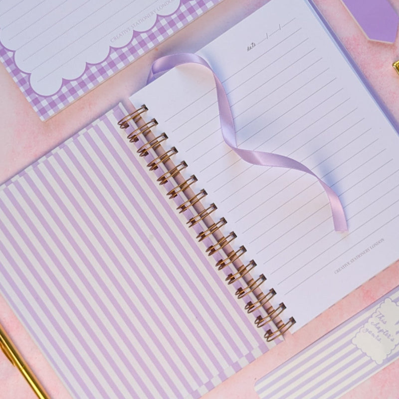 Notebook set with pink and purple accents on a pink background