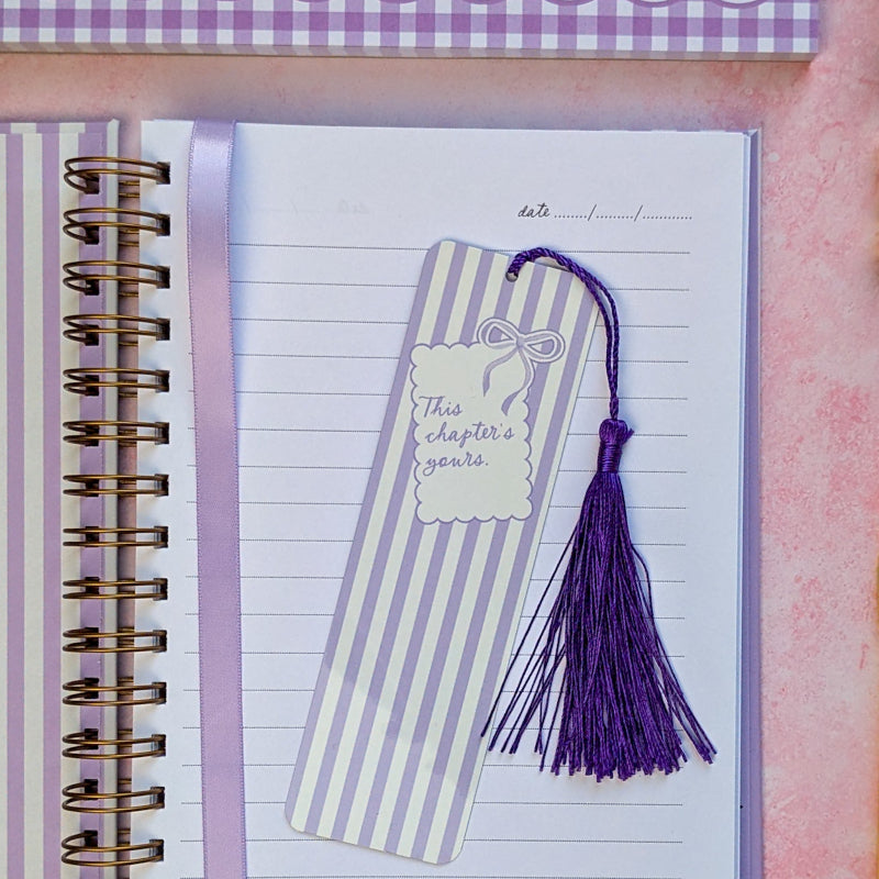 Striped bookmark with tassel on a notebook page
