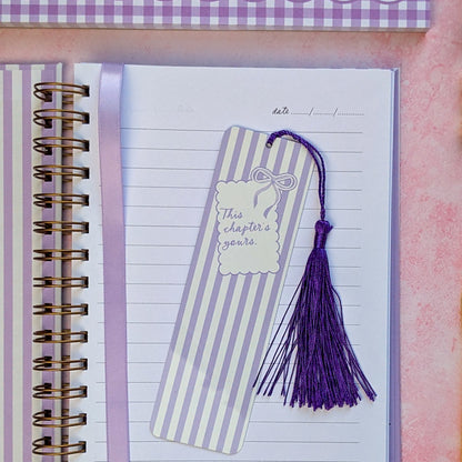 Striped bookmark with tassel on a notebook page