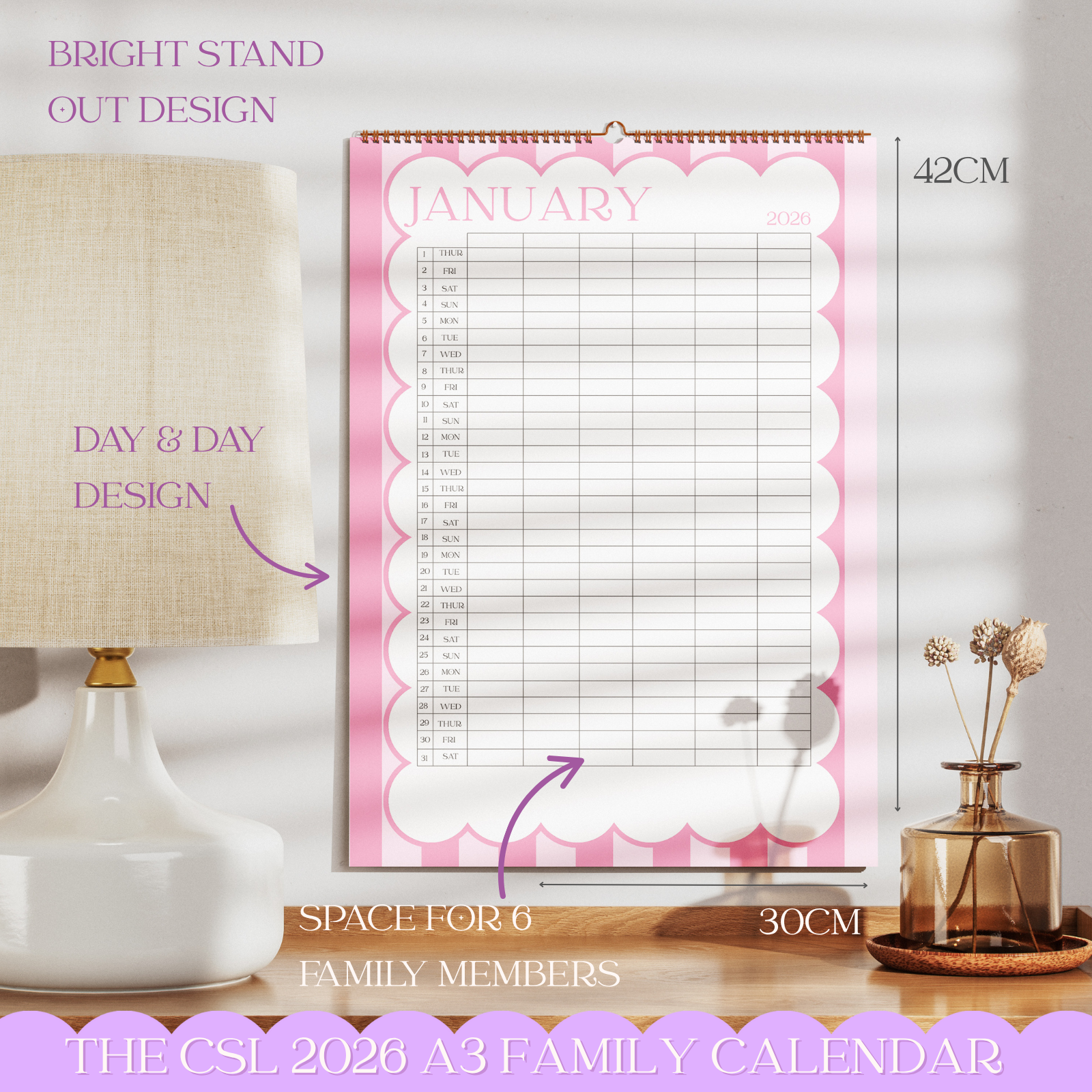 Family calendar with pink design on a table with decorative items